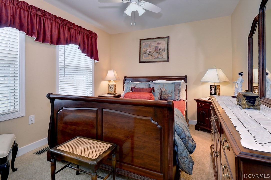 204 Arbordale Loop Williamsburg, VA 23188 - Photo 20 of 41 a bedroom with a bed and a chandelier