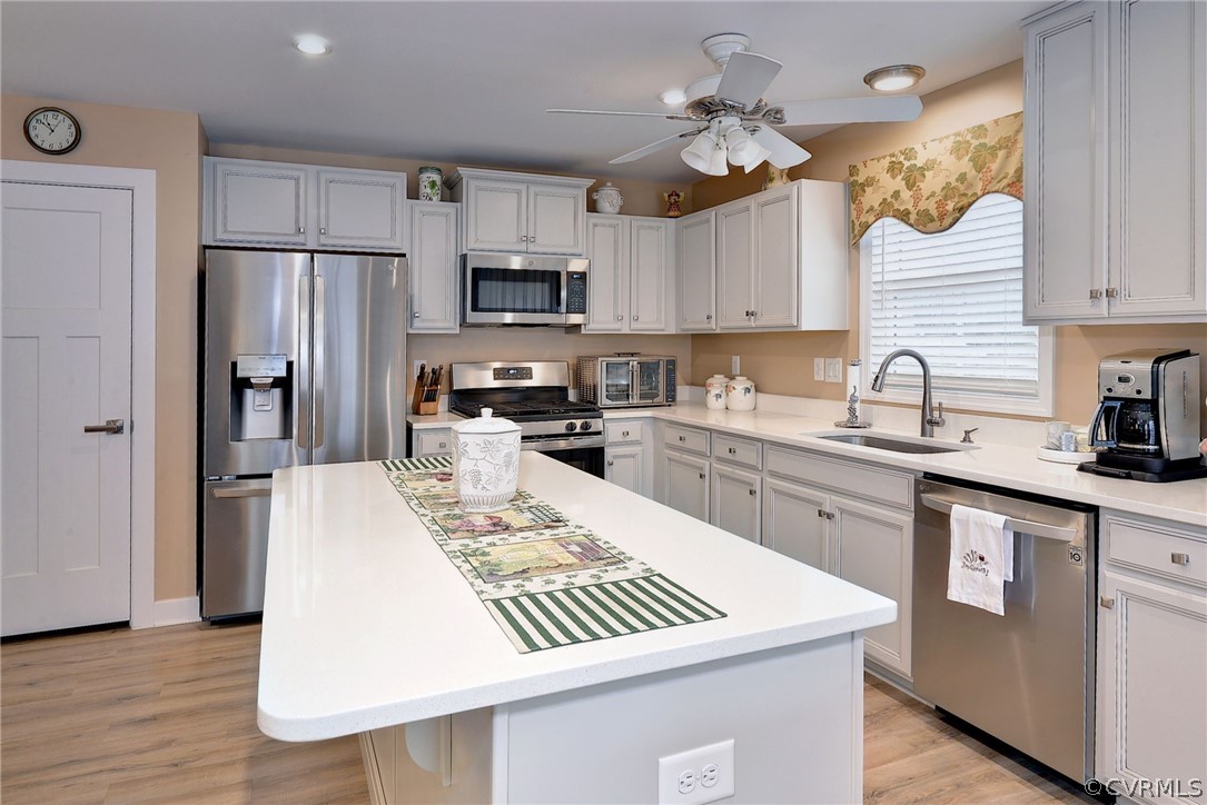204 Arbordale Loop Williamsburg, VA 23188 - Photo 9 of 41 a kitchen with stainless steel appliances granite countertop a sink a stove a refrigerator cabinets and chairs