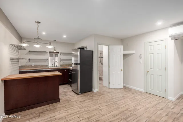 a kitchen with stainless steel appliances granite countertop a refrigerator and a sink