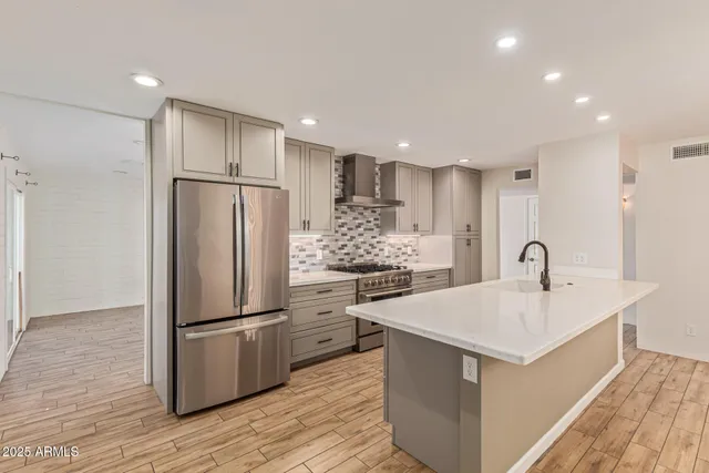 a kitchen with refrigerator cabinets and wooden floor