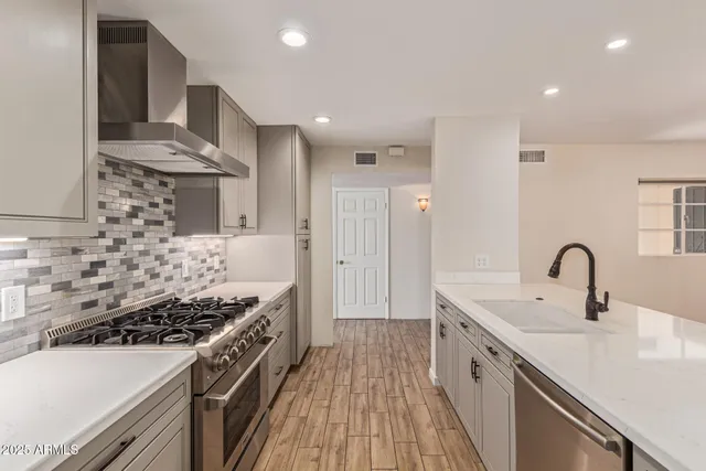 a kitchen with a sink stove and cabinets