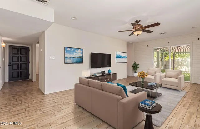 a living room with furniture and a flat screen tv