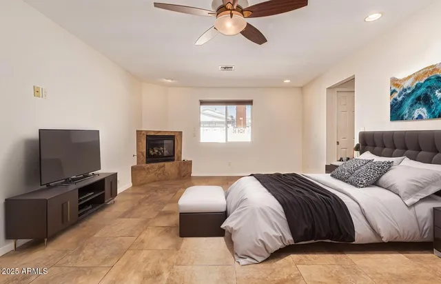 a bedroom with a bed and a flat screen tv