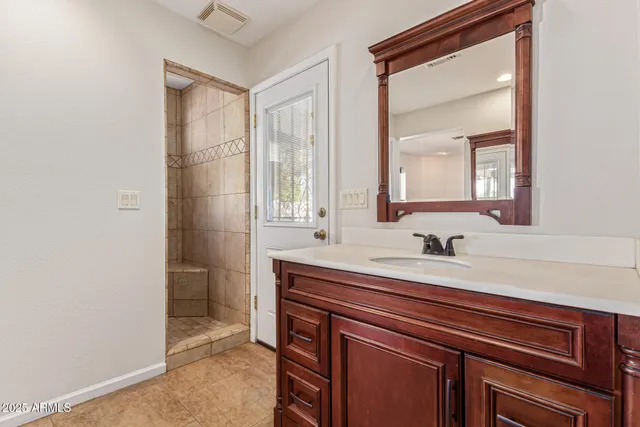 a bathroom with a sink a vanity and a mirror