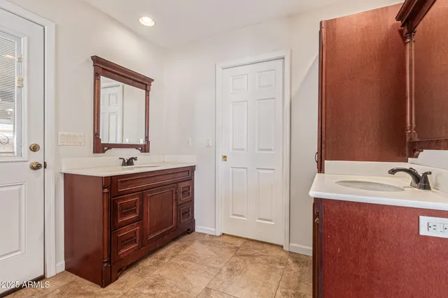 a bathroom with a sink vanity and mirror