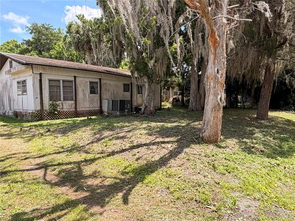 56340 Acorn Road Astor, FL 32102 - Photo 1 of 21 a view of a house with a yard covered with trees