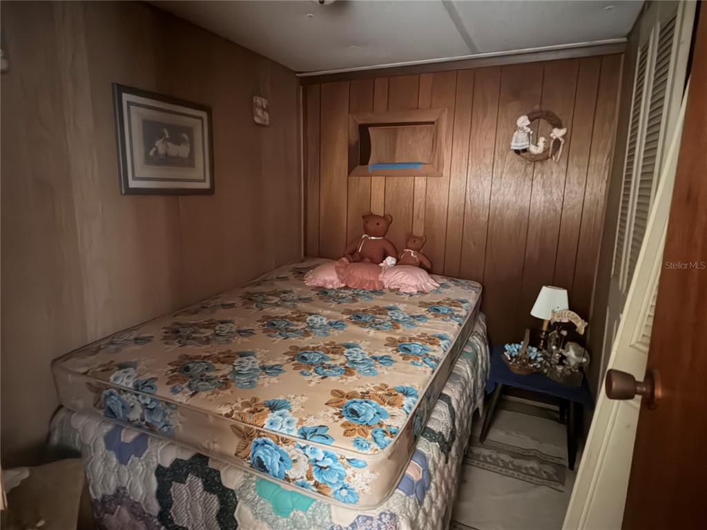 56340 Acorn Road Astor, FL 32102 - Photo 11 of 21 a bedroom with a bed and a painting on the wall