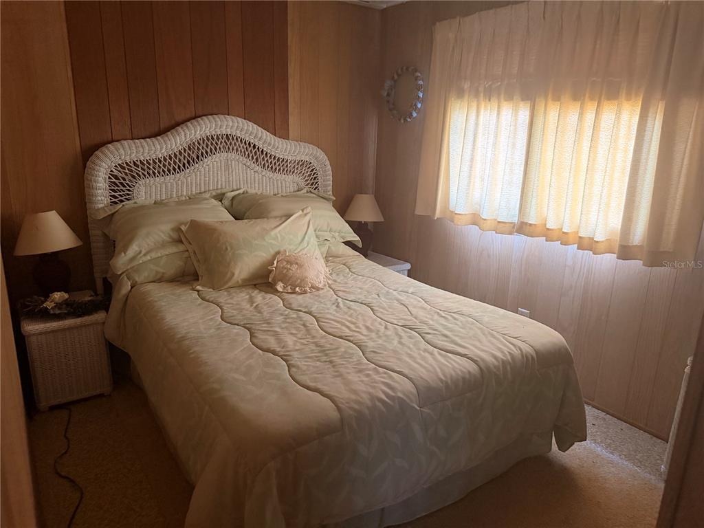 56340 Acorn Road Astor, FL 32102 - Photo 12 of 21 a large bed sitting in a bedroom next to a window