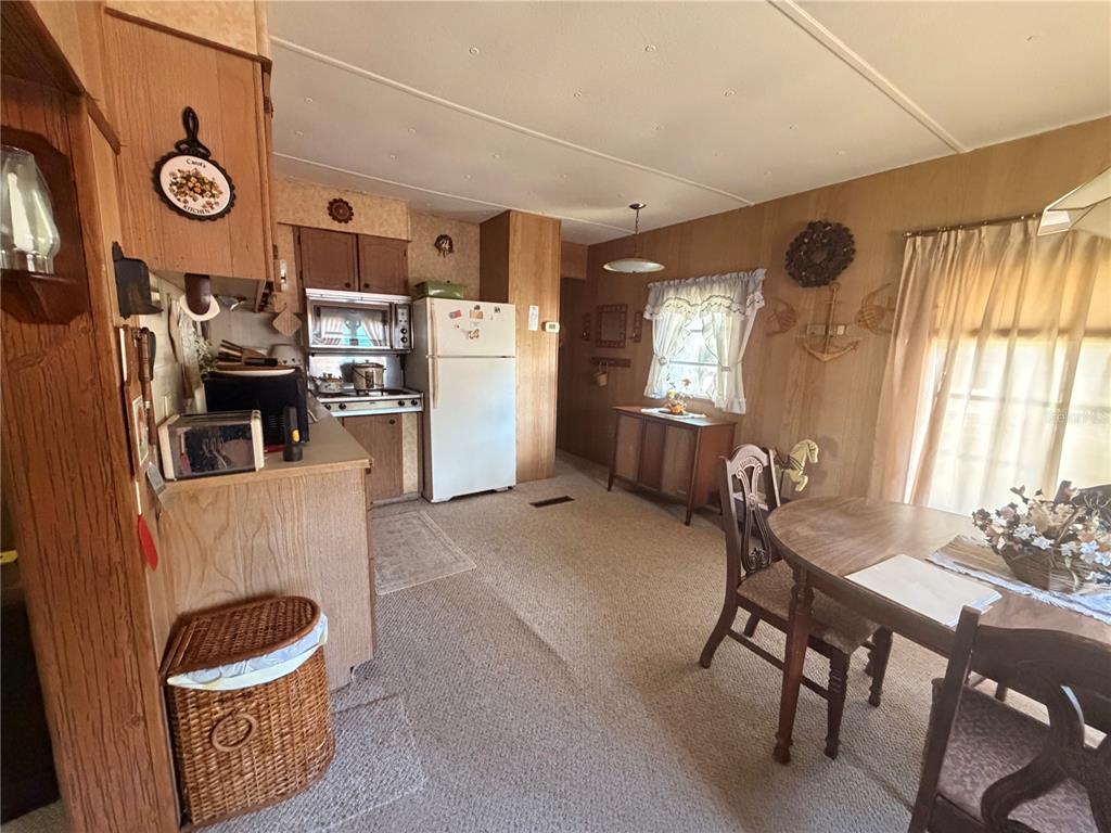 56340 Acorn Road Astor, FL 32102 - Photo 5 of 21 a view of a dining room with furniture and window