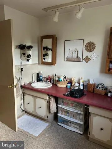 a room with a baby bed furniture and dresser