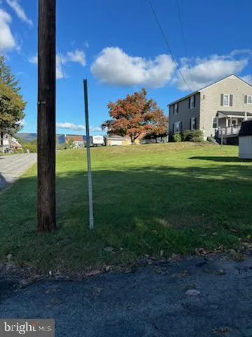 a car parked in front of a house next to a road