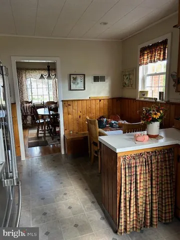 a kitchen with a table chairs and a window