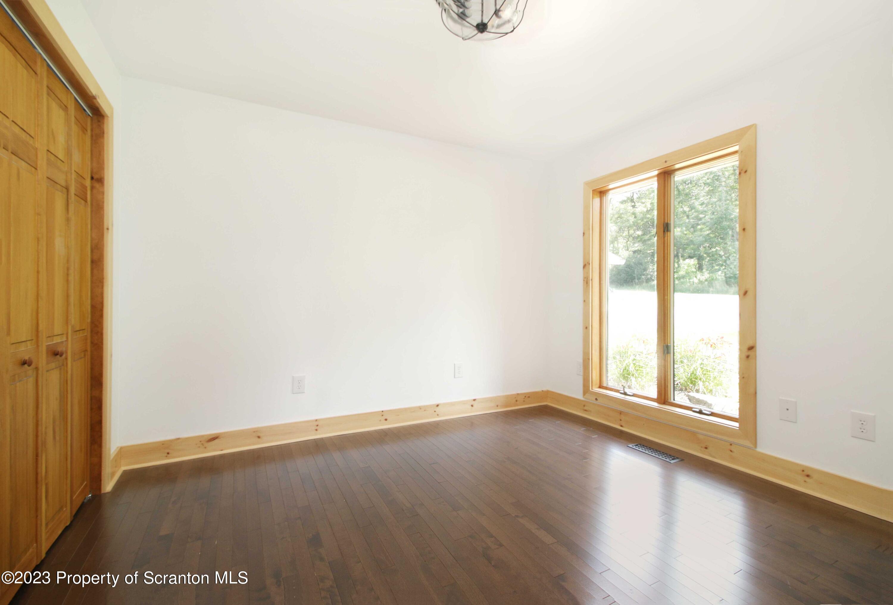761 Day Road Montrose, PA 18801 - Photo 52 of 62 an empty room with wooden floor and windows