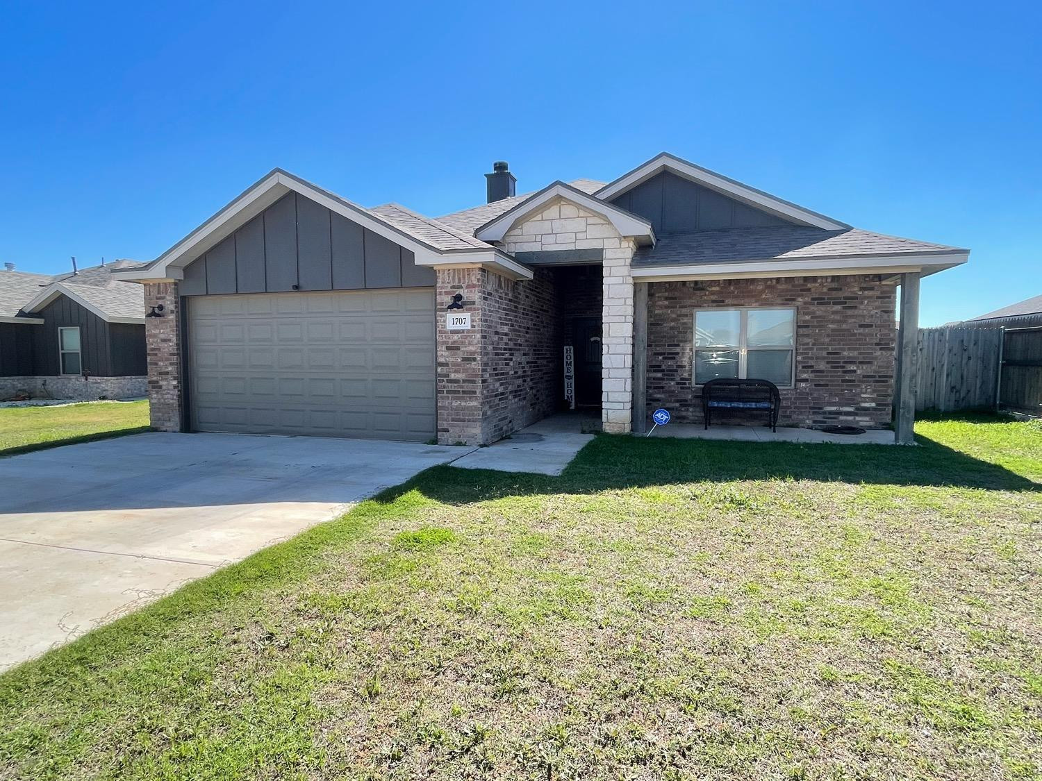 a view of a house with a yard and garage
