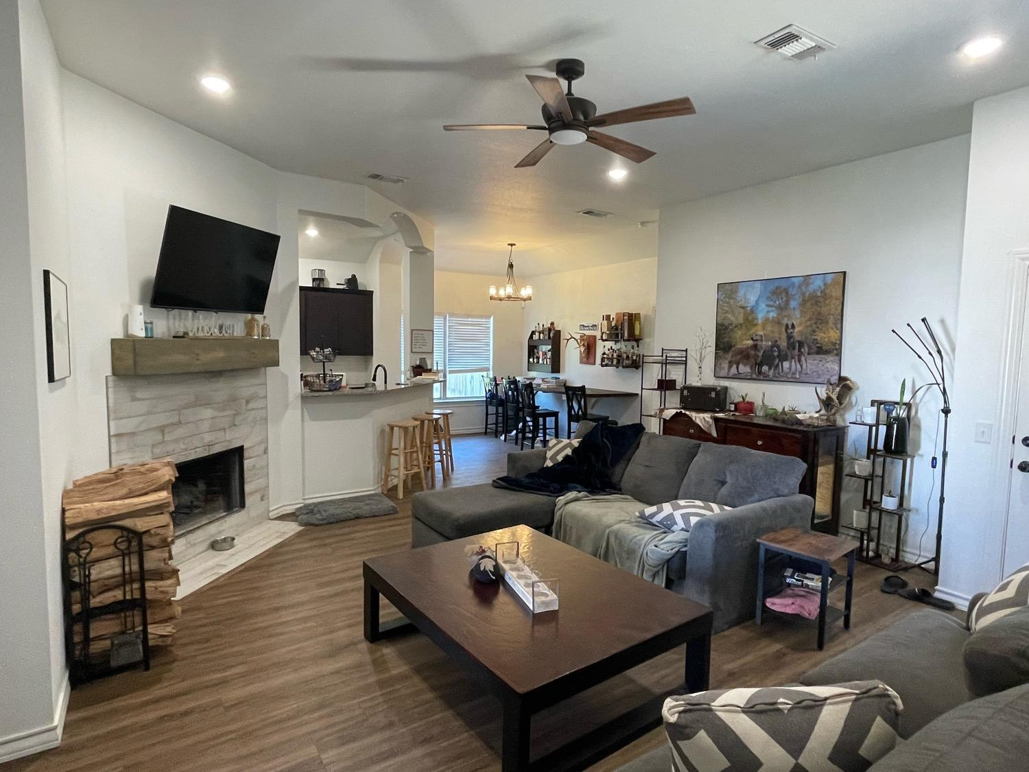 1707 100th Street Lubbock, TX 79423 - Photo 3 of 12 a living room with furniture fireplace and flat screen tv