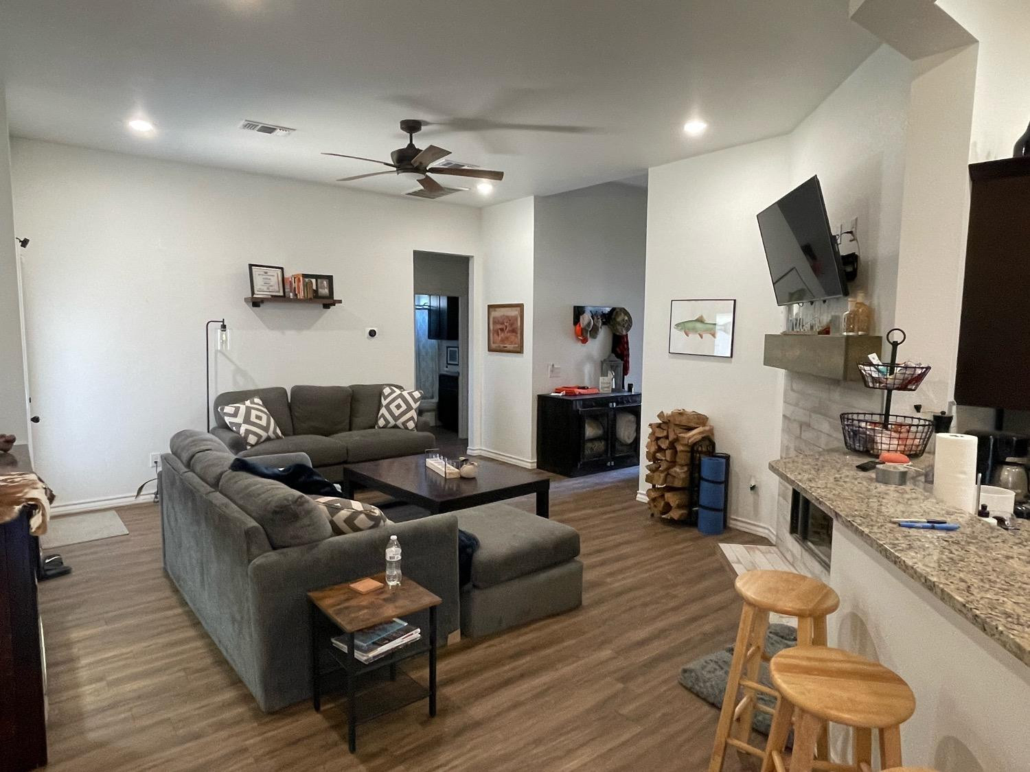 1707 100th Street Lubbock, TX 79423 - Photo 4 of 12 a living room with furniture and a flat screen tv