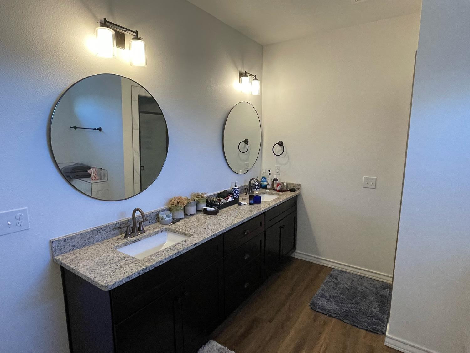 1707 100th Street Lubbock, TX 79423 - Photo 9 of 12 a bathroom with a sink and a mirror