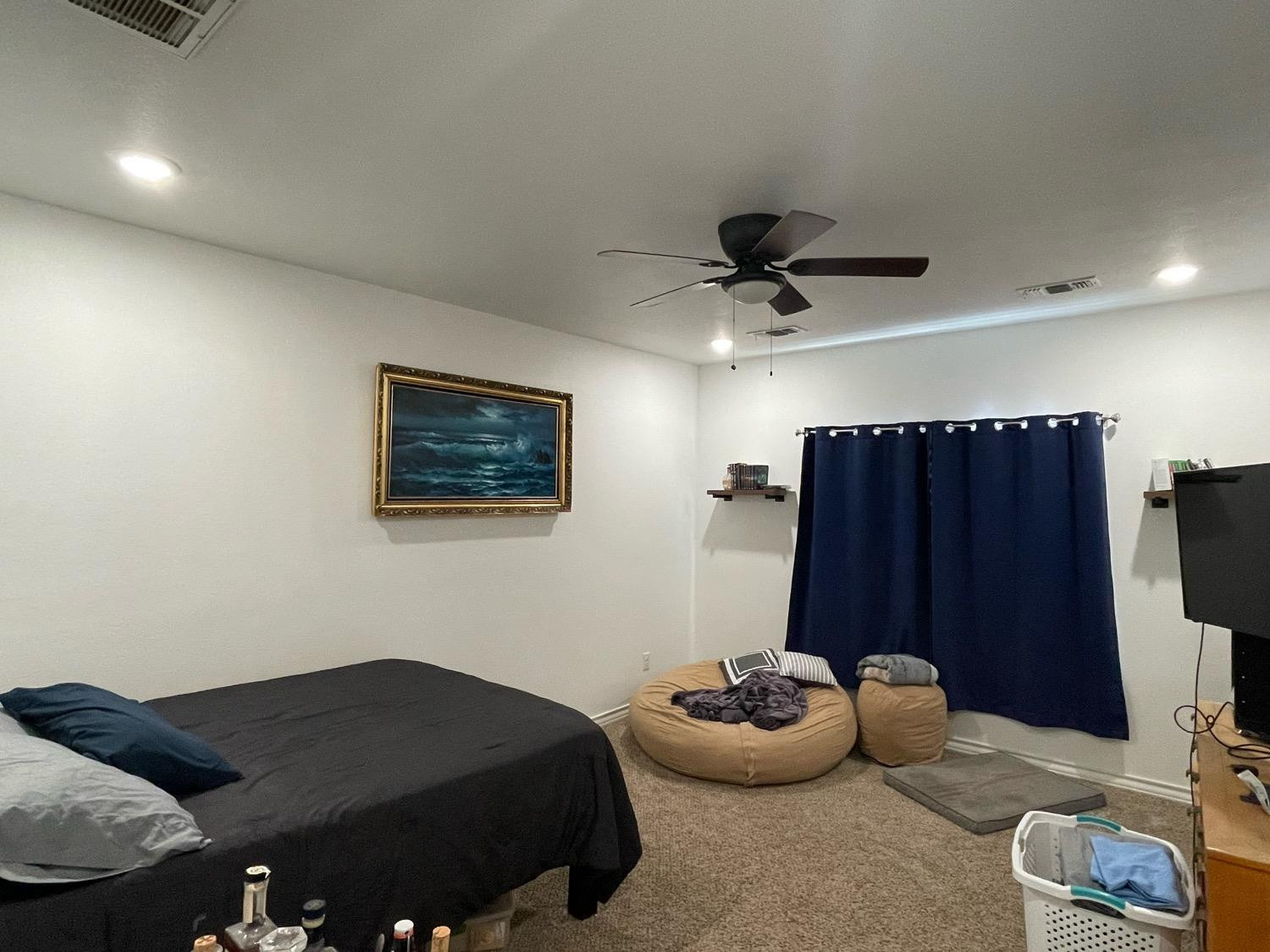 1707 100th Street Lubbock, TX 79423 - Photo 10 of 12 a bedroom with bed and a ceiling fan