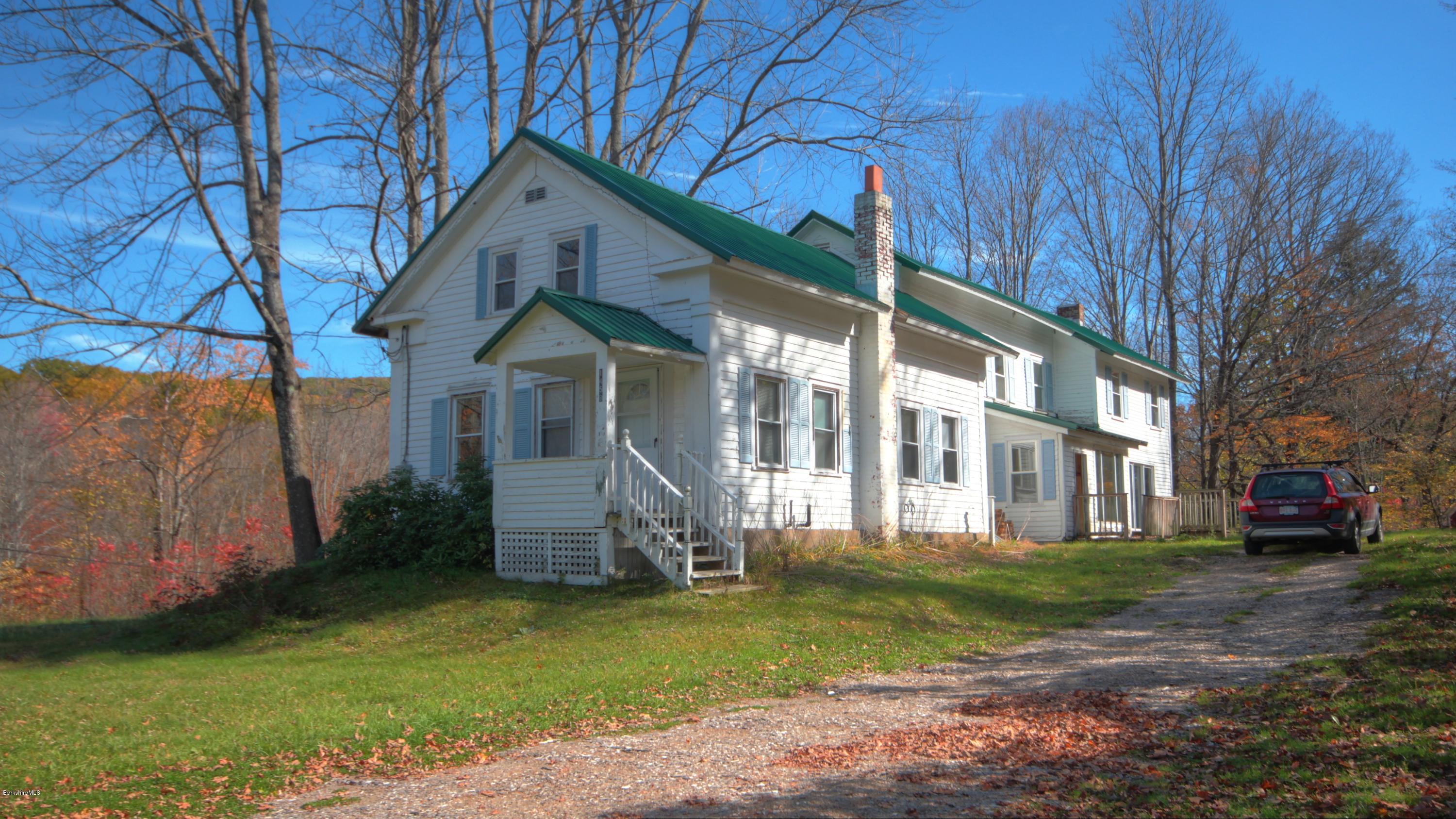 1458 Bancroft Road Becket, MA 01223 - Photo 1 of 19 a front view of a house with a garden