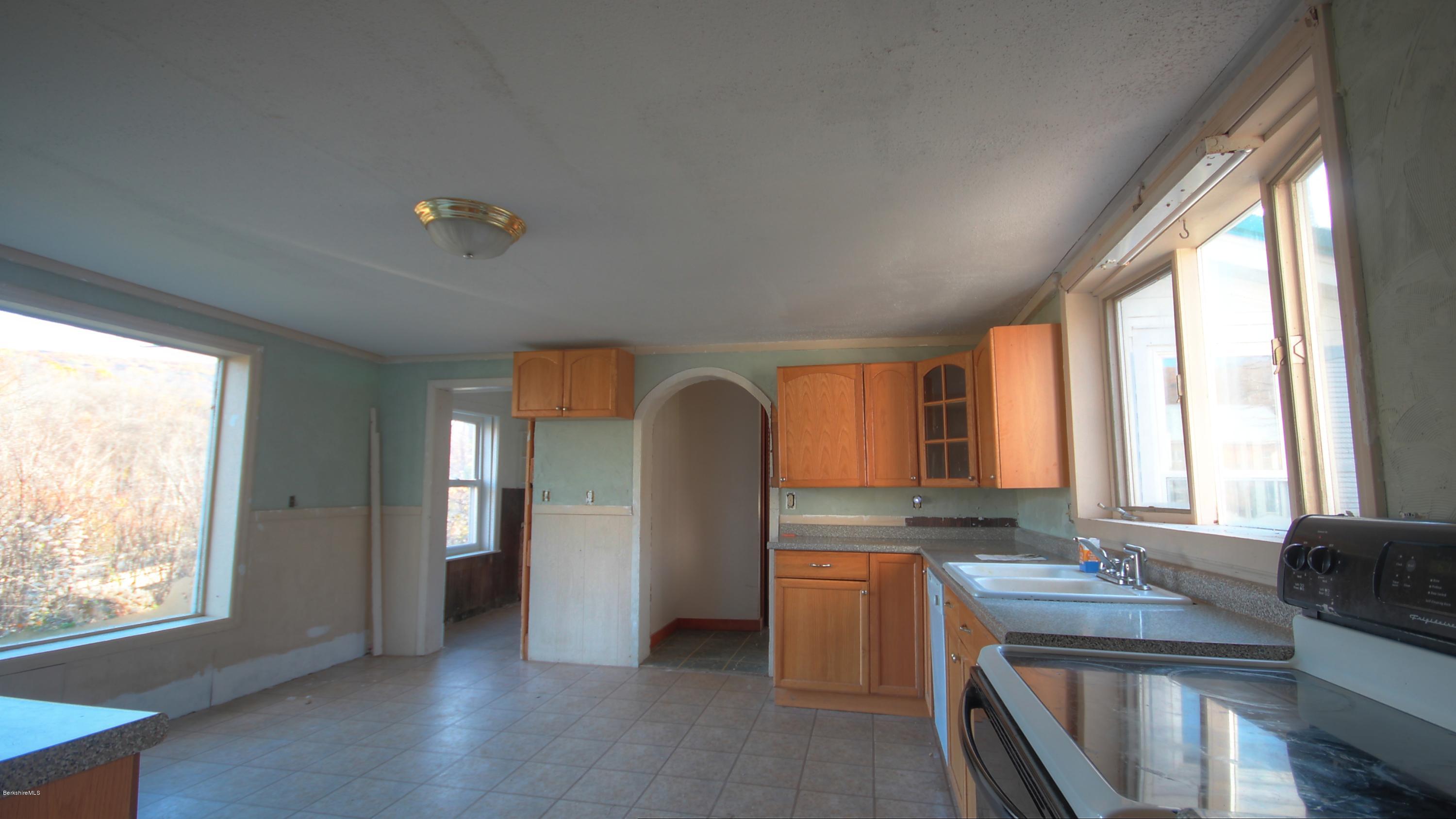 1458 Bancroft Road Becket, MA 01223 - Photo 3 of 19 a view of kitchen with windows and refrigerator