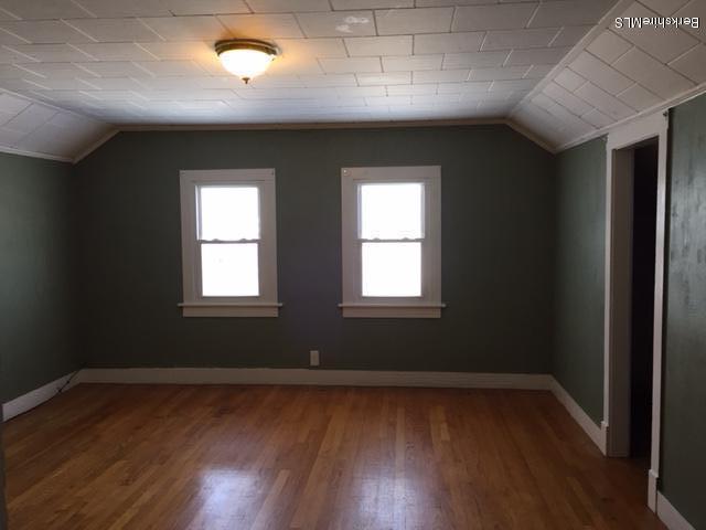 1458 Bancroft Road Becket, MA 01223 - Photo 8 of 19 an empty room with wooden floor and windows