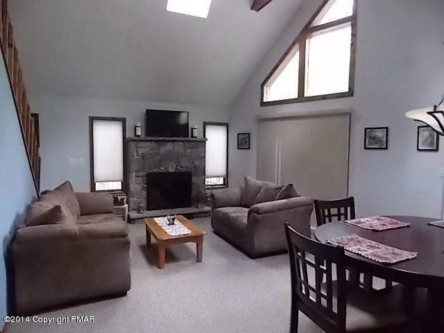 184 Fawn Road Pocono Lake, PA 18347 - Photo 8 of 23 a living room with furniture a flat screen tv and a fireplace