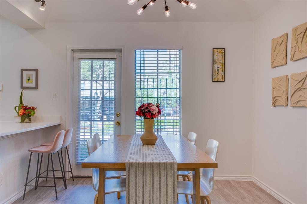 3105 San Jacinto Street, Unit 104 Dallas, TX 75204 - Photo 12 of 36 a view of a dining room with furniture and wooden floor