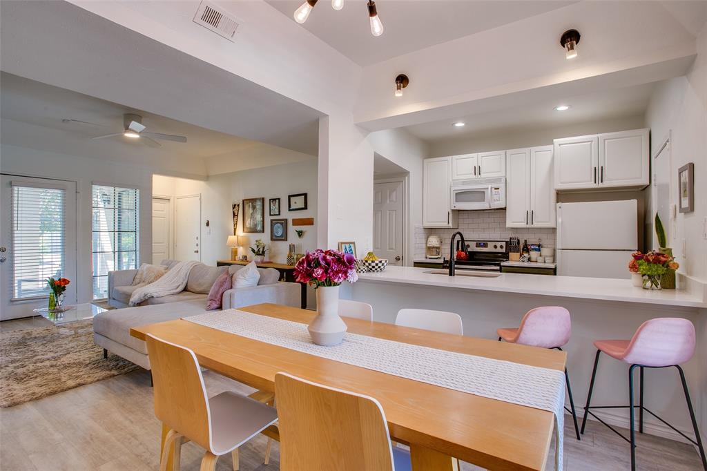 3105 San Jacinto Street, Unit 104 Dallas, TX 75204 - Photo 15 of 36 a kitchen with a dining table chairs and refrigerator