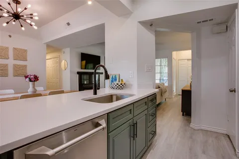 a kitchen with a sink and a refrigerator