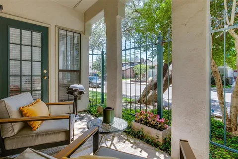 a living room filled with furniture and a potted plant