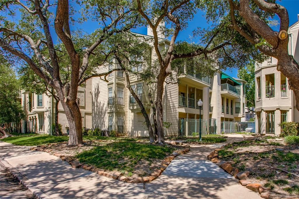 3105 San Jacinto Street, Unit 104 Dallas, TX 75204 - Photo 35 of 36 a view of a brick house with a large tree
