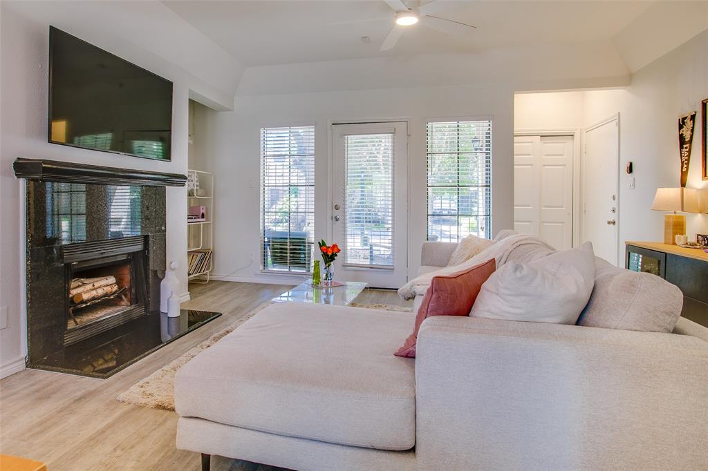 3105 San Jacinto Street, Unit 104 Dallas, TX 75204 - Photo 5 of 36 a living room with furniture a flat screen tv and a fireplace