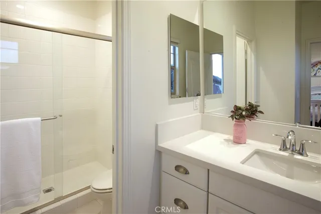 a bathroom with a shower sink and mirror