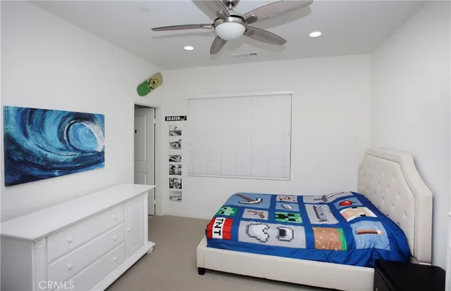 a bedroom with a bed and a dresser