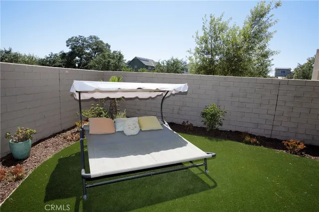 a view of a house with a yard and sitting area