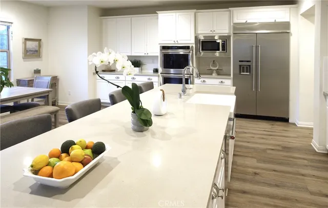 a kitchen with a sink appliances and cabinets