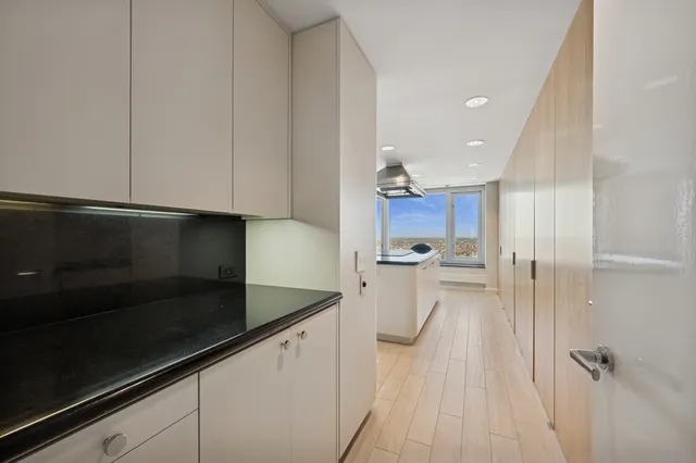 a view of a kitchen with sink microwave and stove