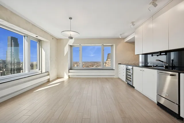 a view of a a dining room with furniture window and wooden floor