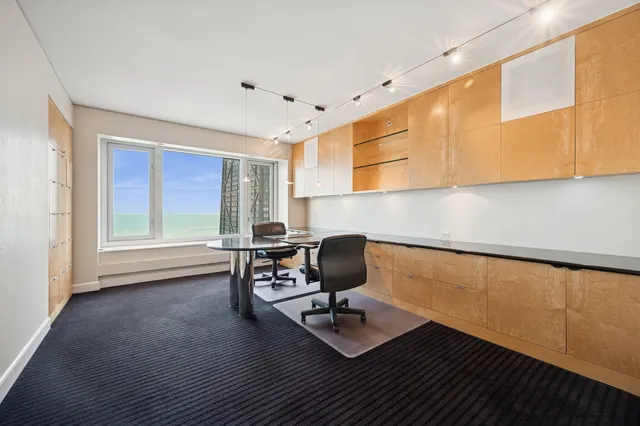 a view of an empty room with a fireplace and a window
