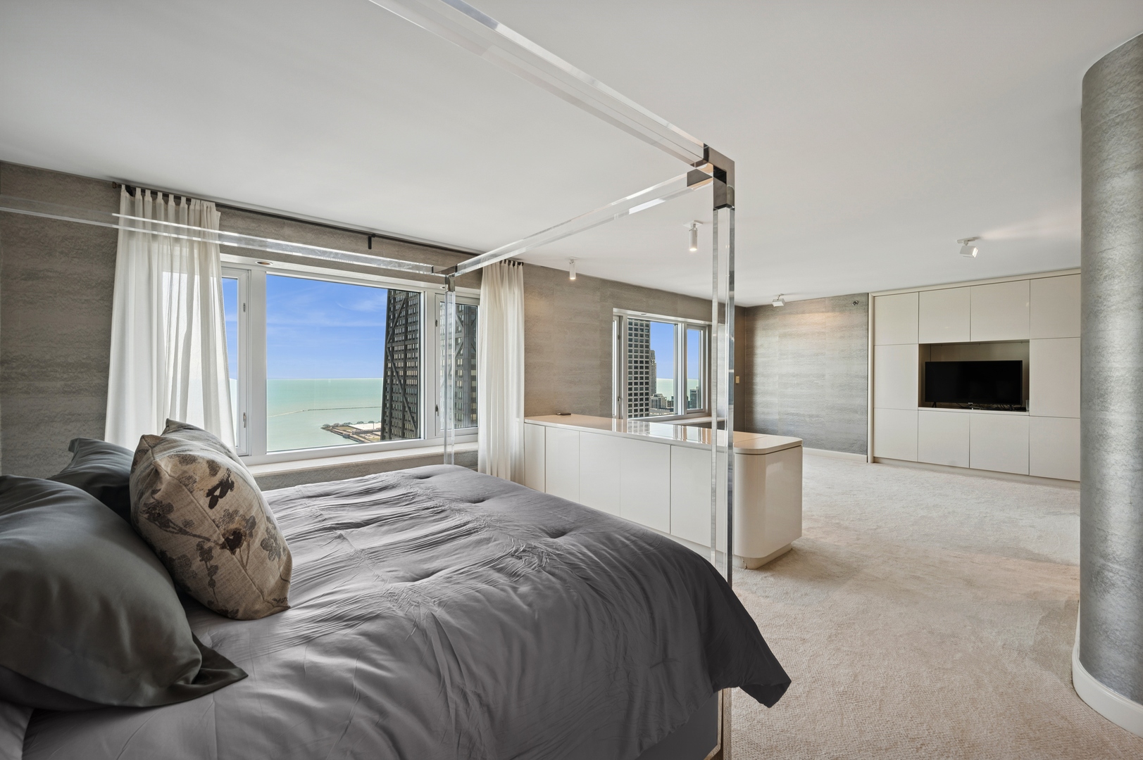 132 East Delaware Place, Unit 5201 Chicago, IL 60611 - Photo 21 of 42 a bedroom with a large bed a flat screen tv and windows