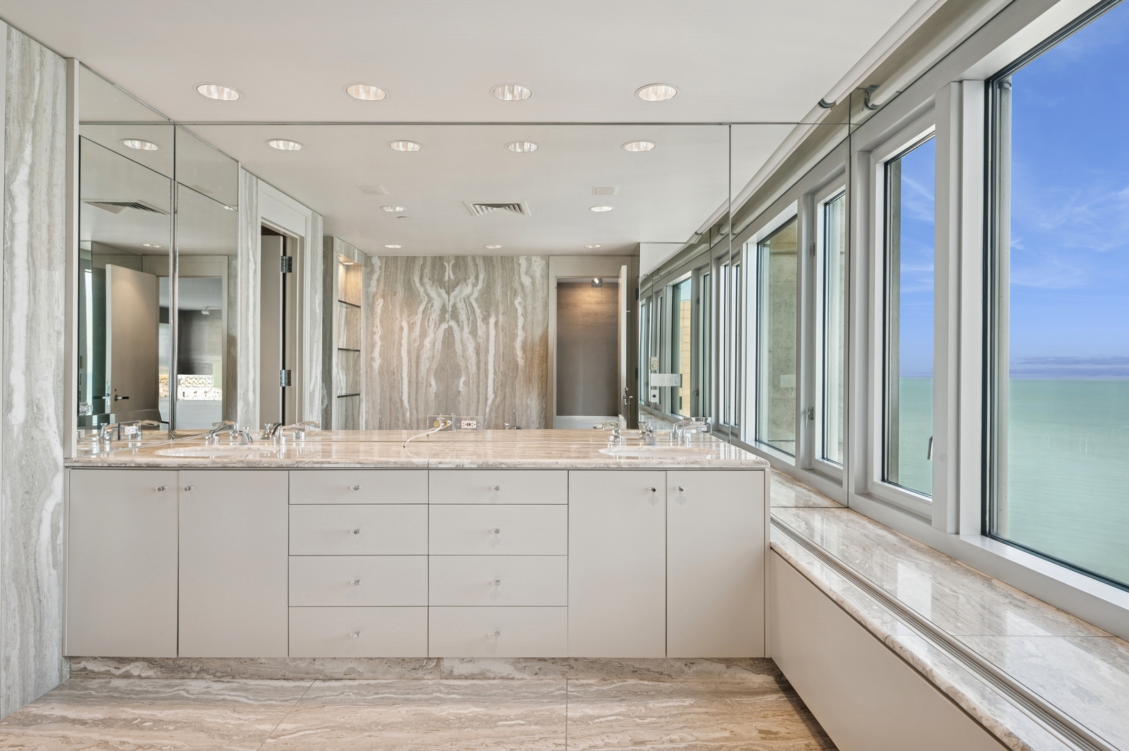 132 East Delaware Place, Unit 5201 Chicago, IL 60611 - Photo 23 of 42 a bathroom with a granite countertop sink vanity and mirror