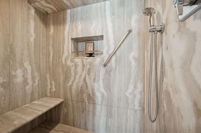 a bathroom with a granite countertop sink mirror and toilet