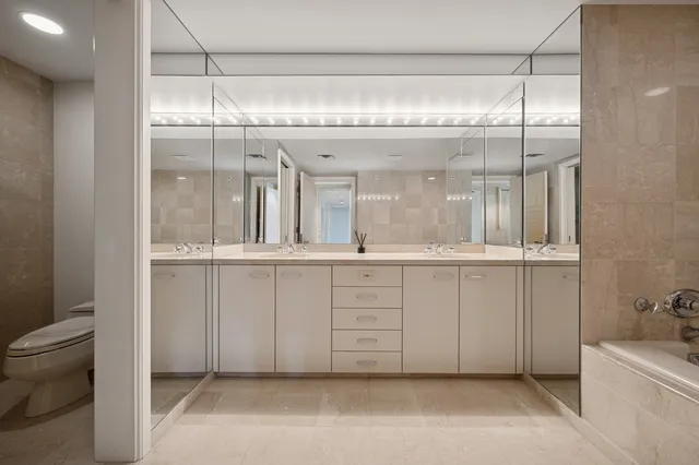 a view of living room kitchen with furniture and windows