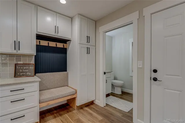a bathroom with a toilet a sink and mirror