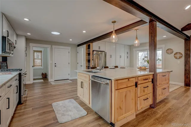a kitchen with stainless steel appliances granite countertop a stove and a sink