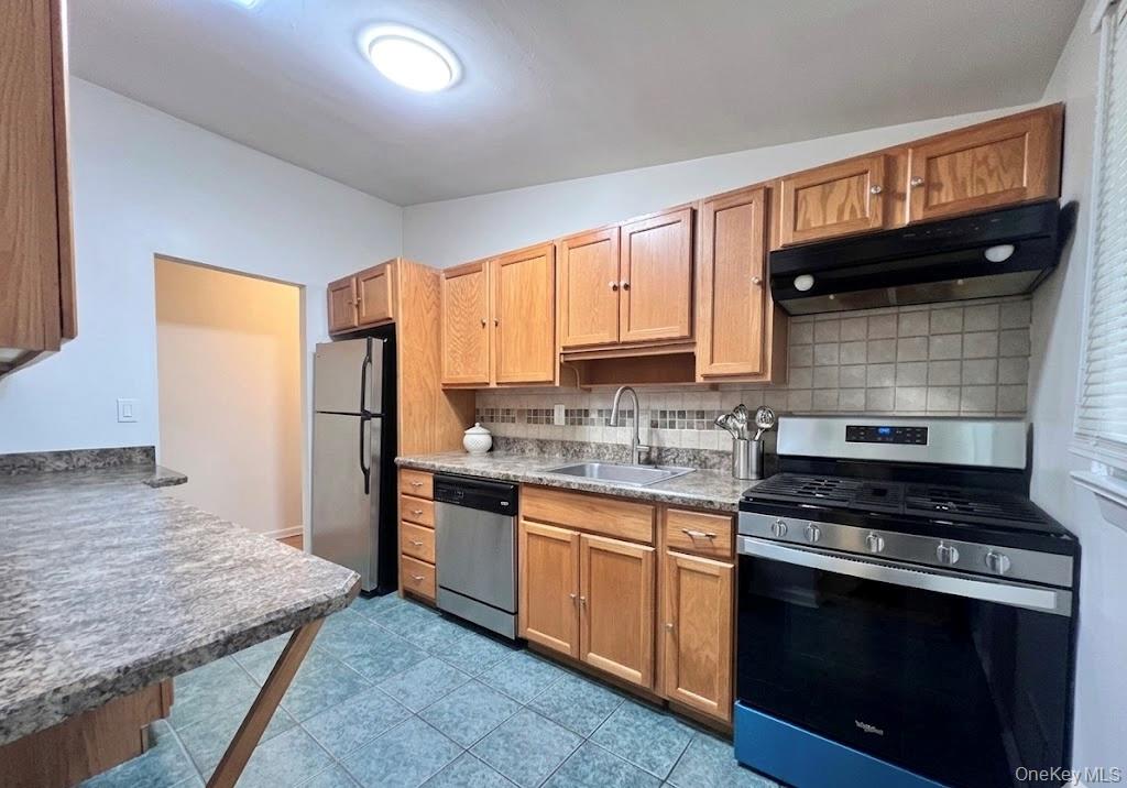 51 North Pascack Road Nanuet, NY 10954 - Photo 5 of 23 a kitchen with granite countertop wooden cabinets and a stove top oven