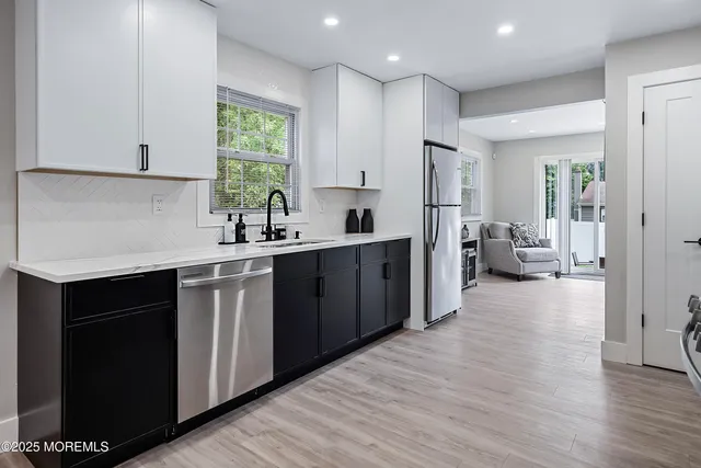 a large bed sitting in a bedroom next to a window