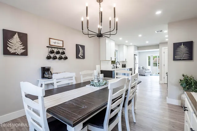 a living room with furniture and a wall painting