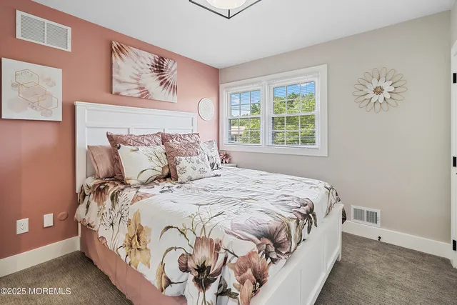 a kitchen with stainless steel appliances granite countertop a refrigerator a sink dishwasher a stove and a dining table with wooden floor