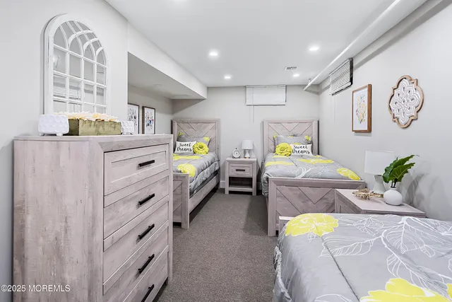 a bedroom with a bed next to a window